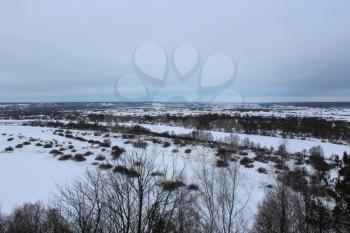 Winter landscape with frozen river and snow from above