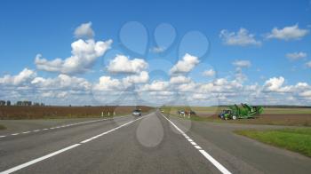 The image of asphalted road and the blue sky