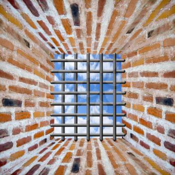 Prison's window and bars in wall from red brick with beams of sun