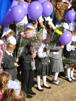 children with flowers and balloons on a holiday  of the 1st september