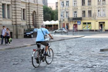 cyclist in the street of Lvov in the central part of city