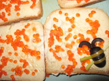 a lot of sandwiches with red caviar