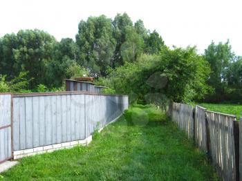 image of fence and little street in rural manor