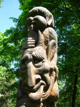 image of sculpture of fabulous personage cut out from a tree