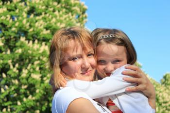 image of mother and daughter are hugging one another