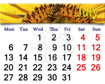 calendar for July of 2015 with fragment of yellow fly on the sunflower