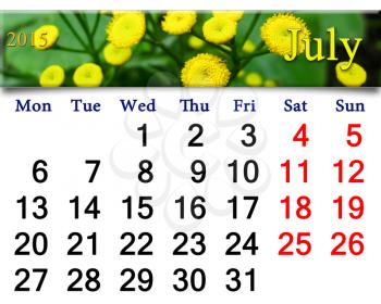 calendar for July of 2015 with fragment of yellow camomiles on the green