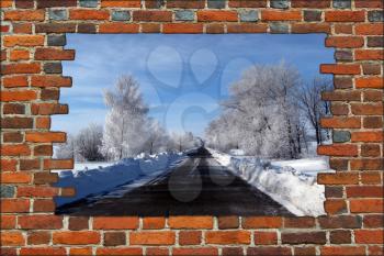 broken brick wall and view to Winter highway with beautiful trees in hoar-frost