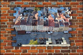 broken brick wall and beautiful view to the house-tops in Lvov city