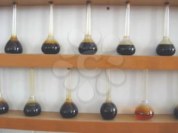 sample of oil in the flasks on the exhibition stend