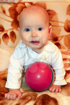 beautiful little baby playing with red ball
