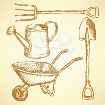 Garden fork, barrow, watering can and shovel, vintage background