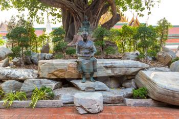 Monk statue in Wat Saket temple in Bangkok, Thailand in a summer day