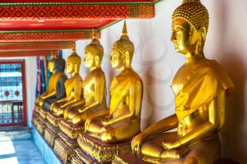 Gold Buddha Statue in Wat Pho Temple in Bangkok in a summer day