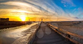 Panorama of Wooden Pier and Lighthouse in Trouville and Deauville in a beautiful summer evening, France