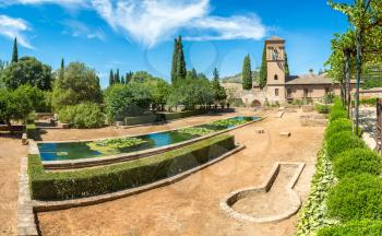 Garden and Bell Tower in Alhambra palace in Granada in a beautiful summer day, Spain
