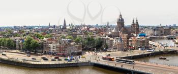 Panorama of Canal and St. Nicolas Church in Amsterdam in a beautiful summer day, The Netherlands