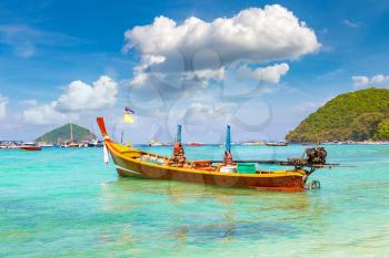 Traditional long tail boat on Coral (Ko He) island near Phuket island, Thailand in a summer day