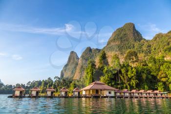 Traditional Thai bungalows at Cheow Lan lake, Ratchaprapha Dam, Khao Sok National Park in Thailand in a summer day