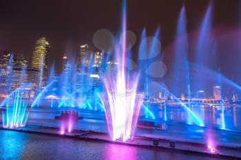 SINGAPORE - JUNE 23, 2018: Fountains night laser show in Singapore near Marina Bay Sands hotel at summer night
