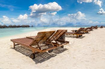 Wooden sunbed on tropical beach in the Maldives at summer day