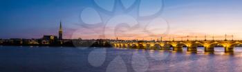 Panorama of Pont de pierre, old stony bridge in Bordeaux in a beautiful summer night, France