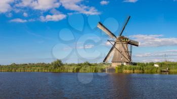 Windmills and water canal in Kinderdijk in a 

beautiful summer day, Holland