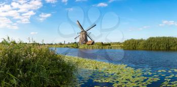 Windmills and water canal in Kinderdijk in a 

beautiful summer day, Holland