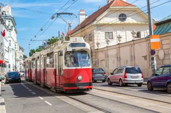 Traditional red electric tram in Vienna, Austria in a beautiful summer day