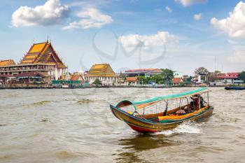 Long tail boat in Chao Phraya river in Bangkok, Thailand in a summer day