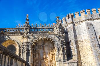 Manueline gate of the Convent of Christ in medieval Templar castle in Tomar in a beautiful summer day, Portugal