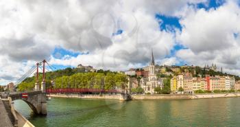 Pedestrian Saint Georges footbridge and the Saint Georges church in Lyon, France in a beautiful summer day