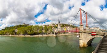 Pedestrian Saint Georges footbridge and the Saint Georges church in Lyon, France in a beautiful summer day