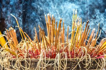 Burning incense sticks in Tran Quoc pagoda in Hanoi, Vietnam in a summer day