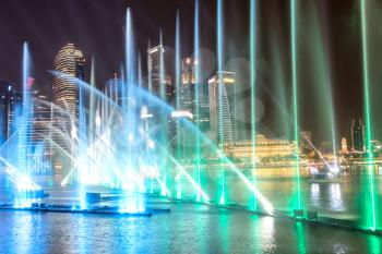 SINGAPORE - JUNE 23, 2018: Fountains night laser show in Singapore near Marina Bay Sands hotel at summer night