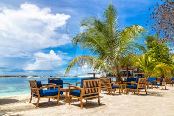 MALDIVES - JUNE 24, 2018: Table and chairs at tropical beach restaurant in the Maldives at summer day