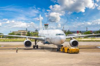 Airplane ready to take off at Velana International Airport in Male, Maldives in a summer day