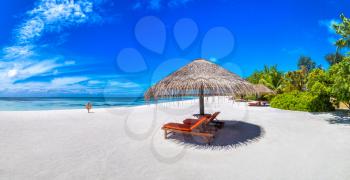 Panorama of Wooden sunbed and umbrella on tropical beach in the Maldives at summer day