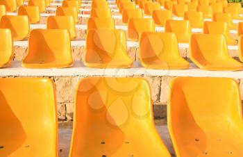 Stadium Yellow Chairs at sun light.