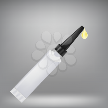 Metal Tube of Super Glue Isolated on Grey Background. Yellow Drop of Glue.