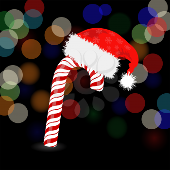 Candy Cane and Hat of Santa Claus 0n Dark Blurred Background