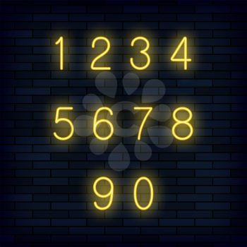 Set of Yellow Neon Numbers Isolated on Dark Brick Background
