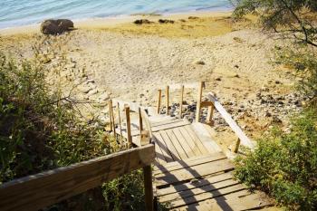 Wooden staircase to the sea, made of old pallets - ecological material.