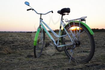 Bicycle in the stubble in a wheat field
