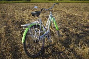 Bicycle in the stubble in a wheat field