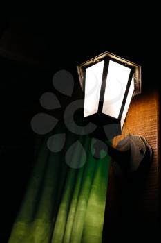 Night lamp on the blackboard and curtains. Romantic scene