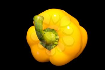 Photo of yellow raw pepper on black background