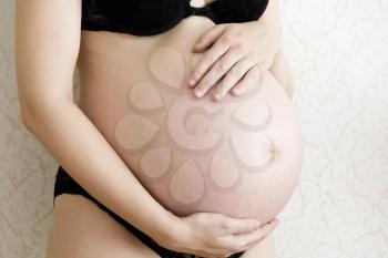 Image of pregnant woman in black underwear
