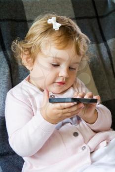Cute baby girl with new mobile phone