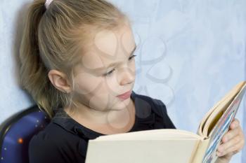 Image of cute girl reading a book